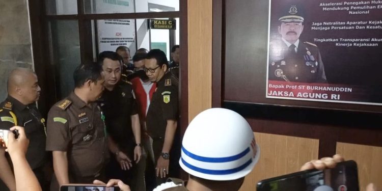 Tersangka GAS saat keluar dari ruang penyidik Kejati Sultra.